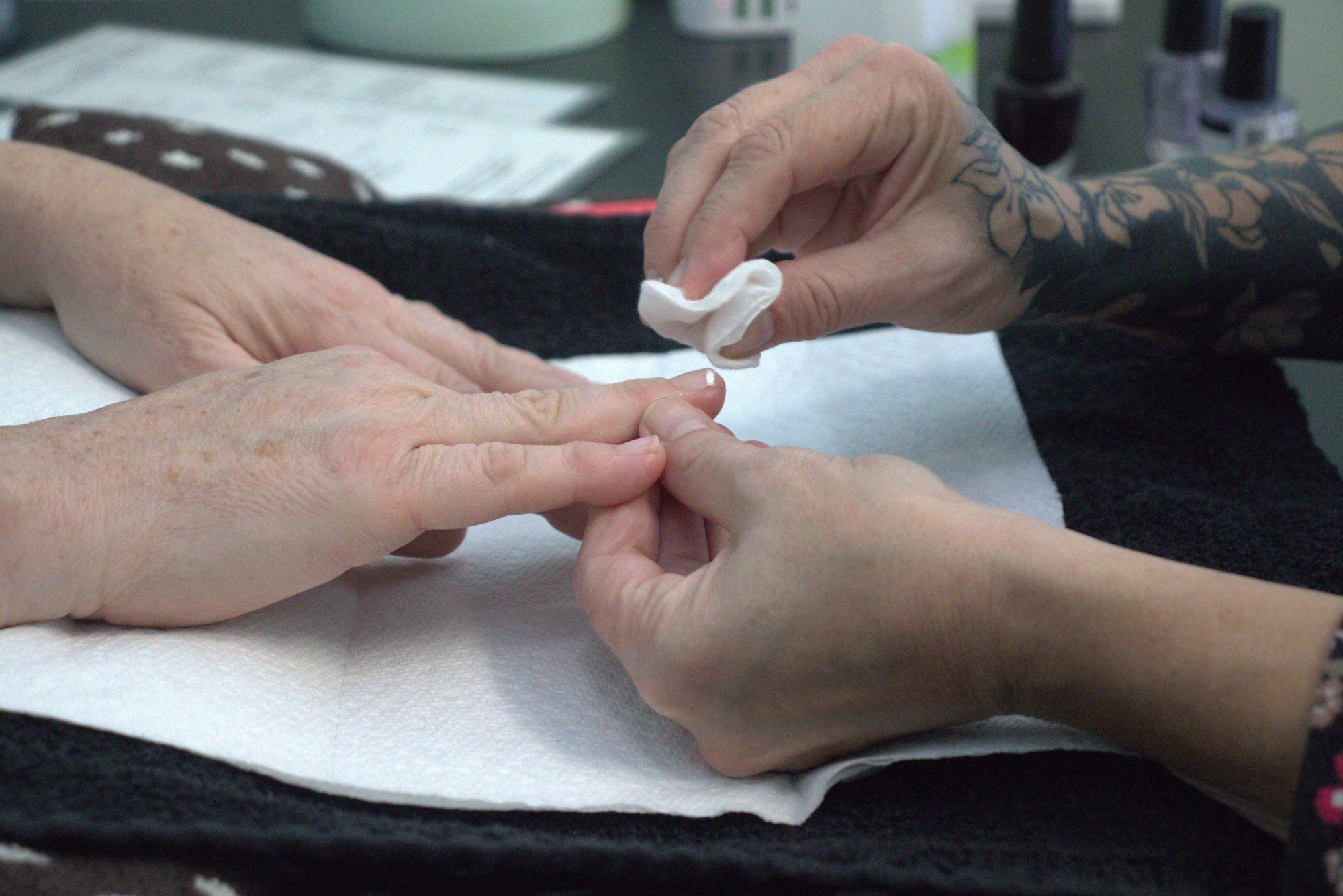 A manicure in progress, with cuticle care at the table